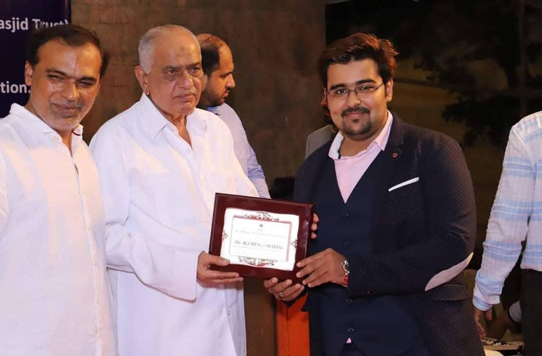 Ali being felicitated with a certificate