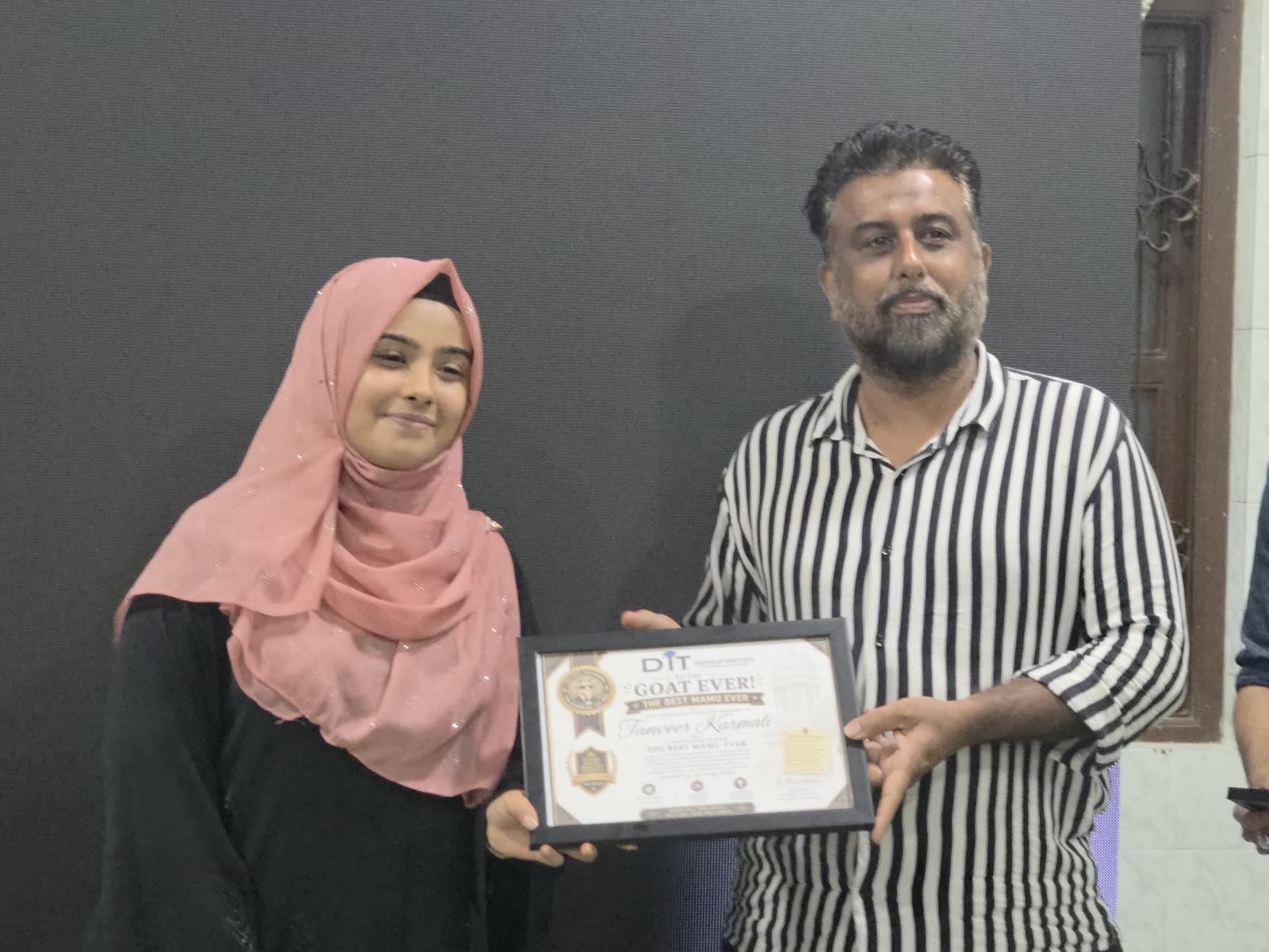 A participant receiving her completion certificate
