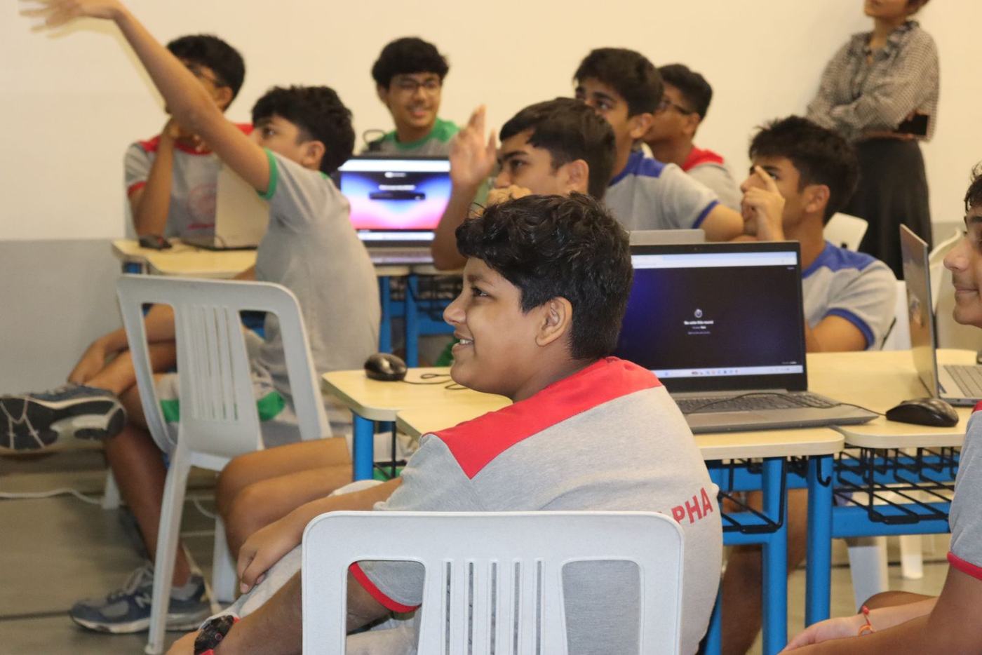 A student shooting his hand up to answer