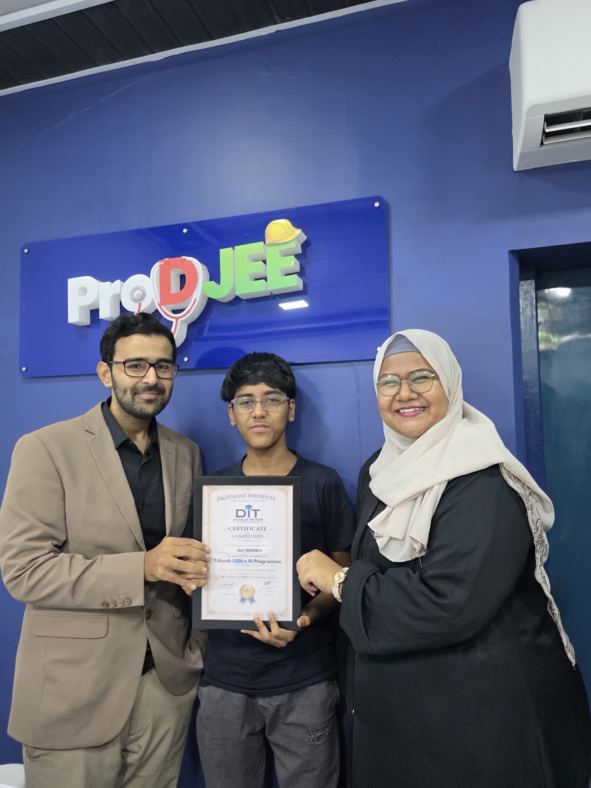 A graduate receiving a certificate from Ali