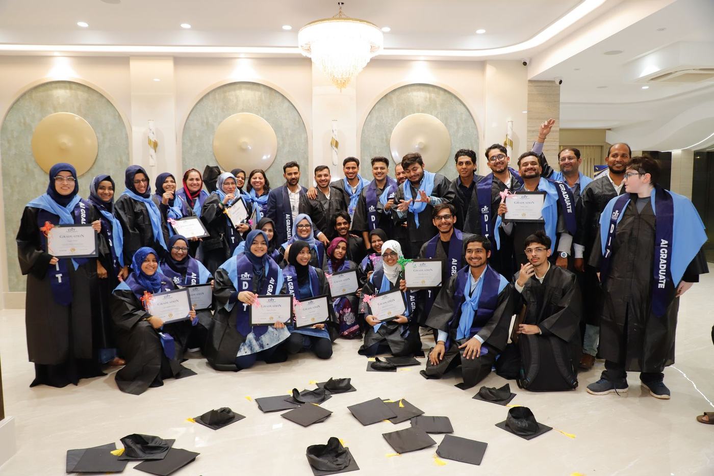 The batch celebrating with caps on the floor