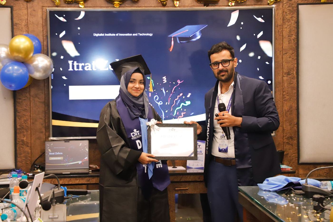 A graduate receives her certificate on stage