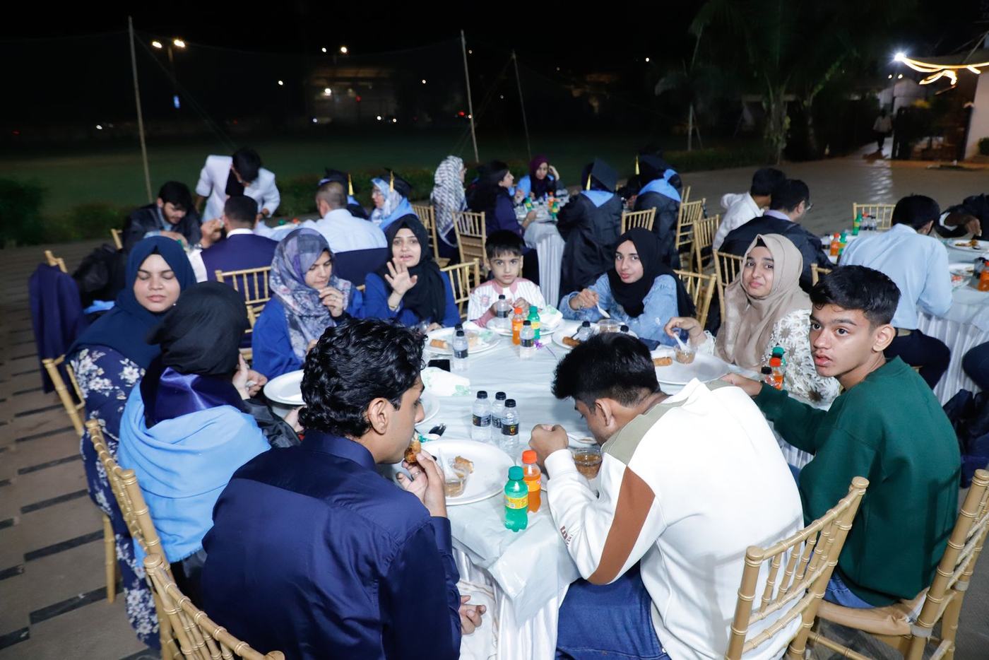 Graduates and families at dinner outdoors