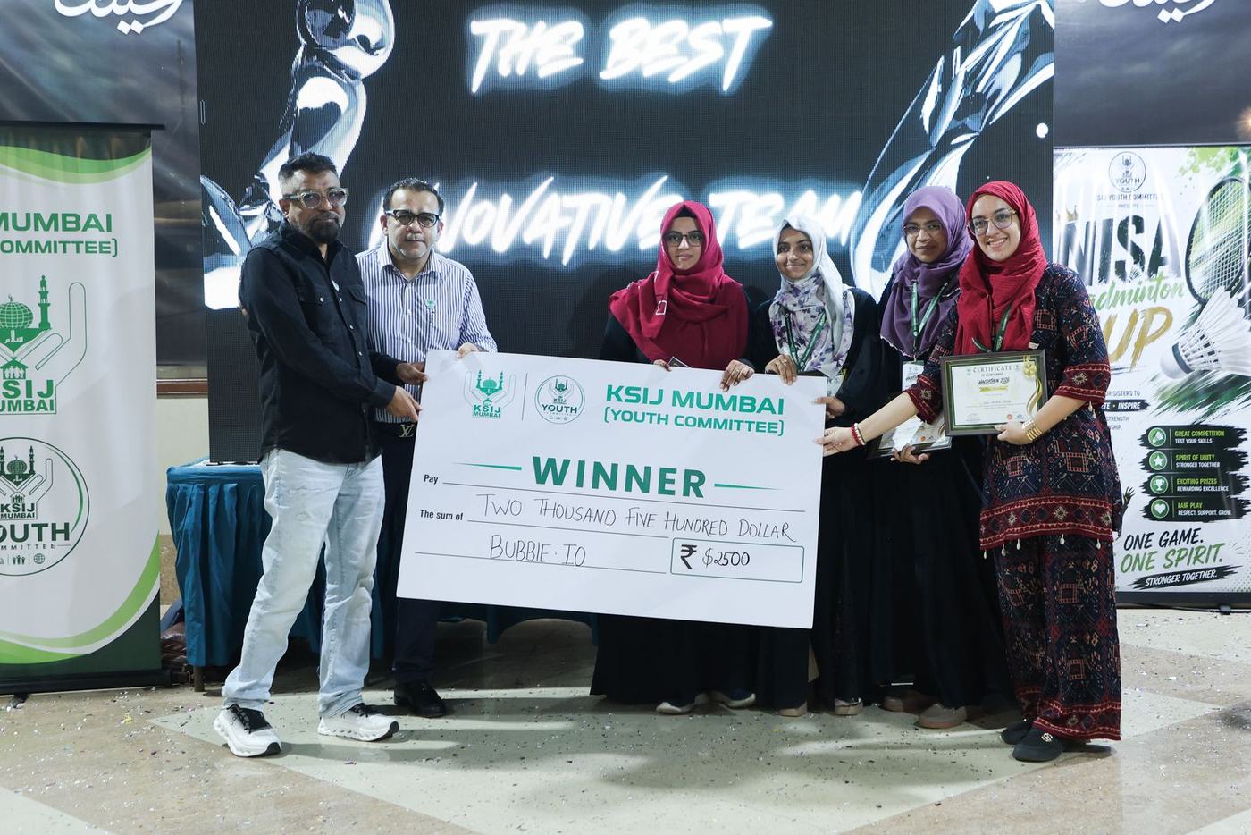 A winning team with the cheque