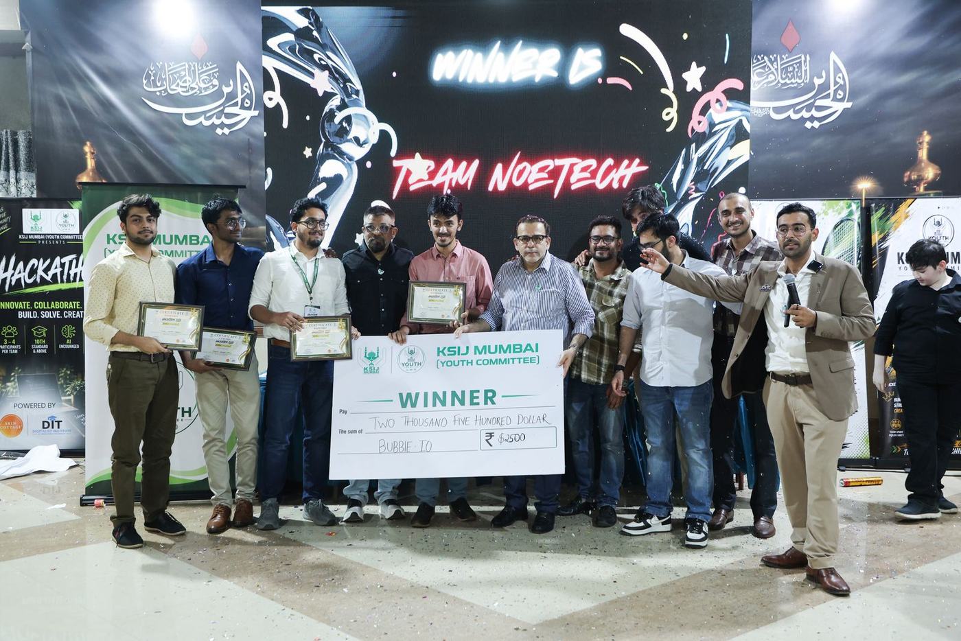 Team NoeTech on stage with the winner's cheque